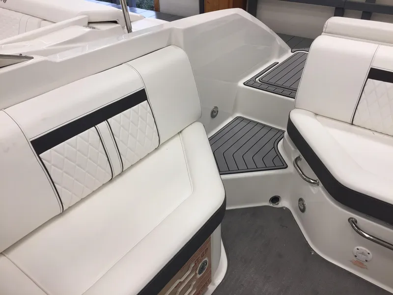 Slide: The Image of 2018 Sea Ray SLX 250 boat interior with white leather seating and sleek design. - 15