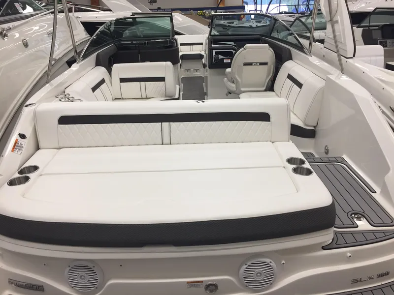 Slide: The Image of 2018 Sea Ray SLX 250 boat interior with white seating and modern design. - 4