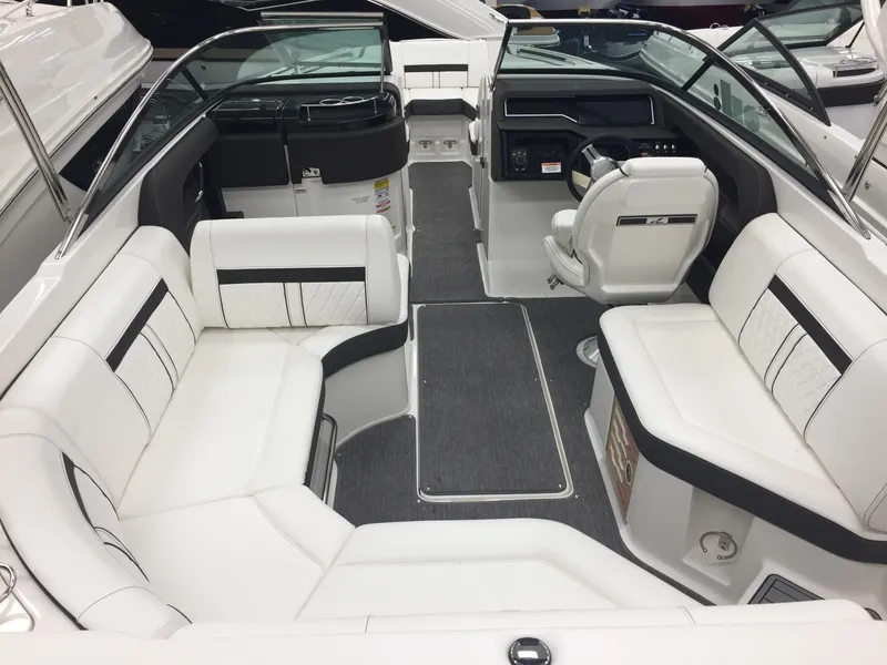 Slide: The Image of Interior of 2018 Sea Ray SLX 250 boat with white seating and modern design. - 7