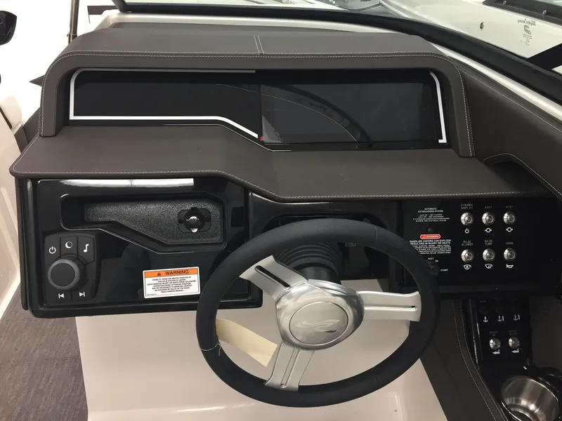 Slide: The Image of 2018 Sea Ray SLX 250 dashboard with steering wheel and control panel. - 9