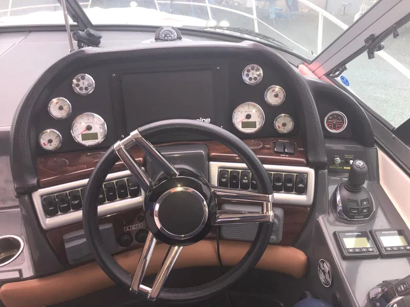 Slide: The Image of 2018 Four Winns V355 boat dashboard with steering wheel and control panel. - 12