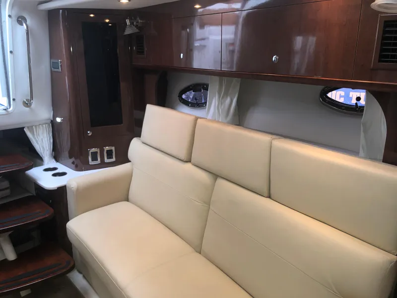 Slide: The Image of Luxurious interior of 2018 Four Winns V355 yacht with beige leather seating. - 19