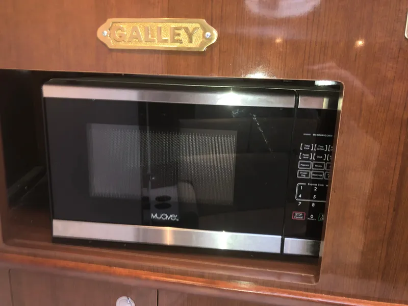 Slide: The Image of Microwave in Four Winns V355 yacht galley, 2018 model, with wood paneling. - 25
