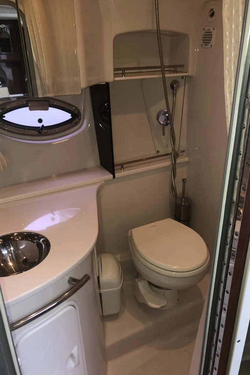 Slide: The Image of 2018 Four Winns V355 boat bathroom with sink, toilet, and shower. - 26
