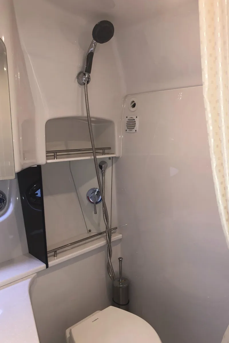 Slide: The Image of 2018 Four Winns V355 boat bathroom with shower and toilet. - 27