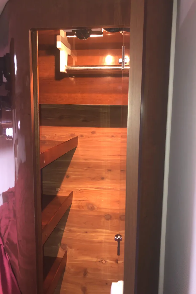 Slide: The Image of Interior of 2018 Four Winns V355 yacht with wooden shelves and warm lighting. - 29