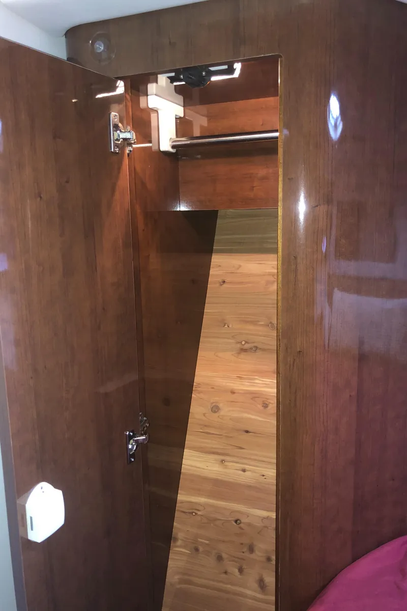 Slide: The Image of 2018 Four Winns V355 interior with wooden cabinetry and closet space. - 31