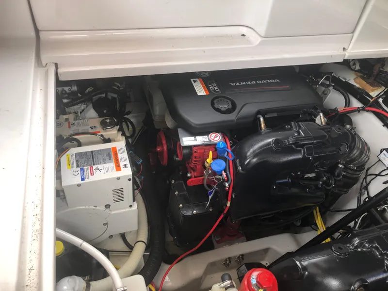 Slide: The Image of Engine compartment of a 2018 Four Winns V355 boat, showcasing mechanical components. - 35
