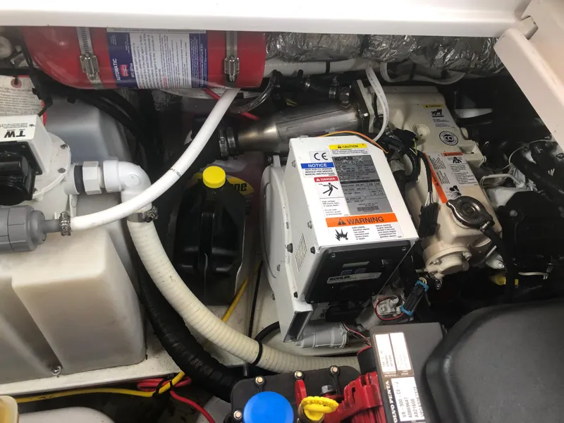 Slide: The Image of Engine compartment of a 2018 Four Winns V355 boat, showcasing mechanical components and wiring. - 36