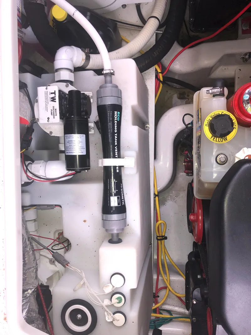 Slide: The Image of Engine compartment of a 2018 Four Winns V355 boat, showcasing various mechanical components. - 38