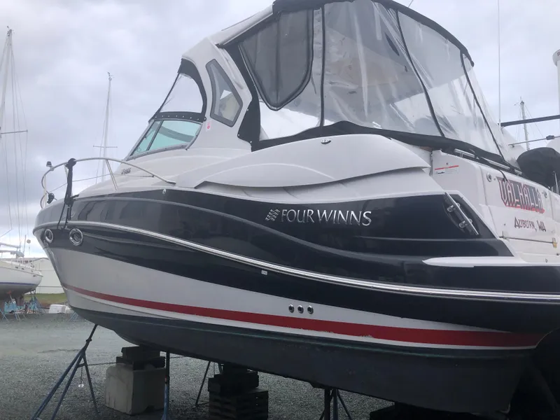 Slide: The Image of 2018 Four Winns V355 boat on stands, side view with canopy. - 4