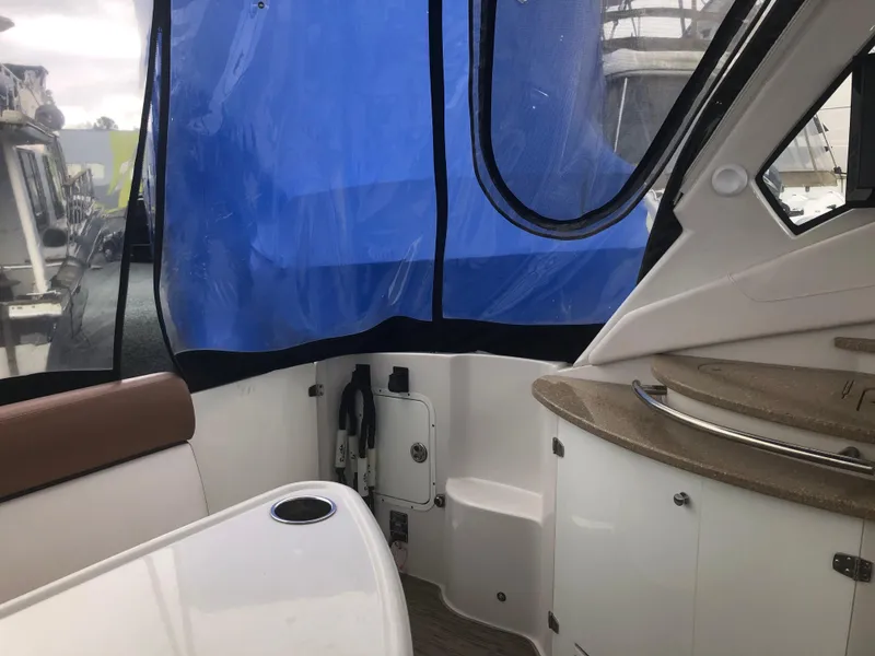 Slide: The Image of Interior view of 2018 Four Winns V355 boat with blue canopy and seating area. - 5