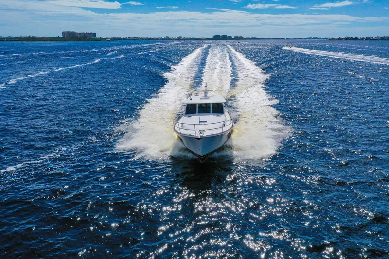 Slide: The Image of 2019 Sabre 45 Salon Express yacht cruising on open water under blue skies. - 101