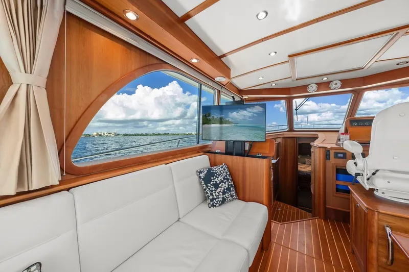 Slide: The Image of 2019 Sabre 45 Salon Express interior with elegant wood finish and scenic ocean view. - 12