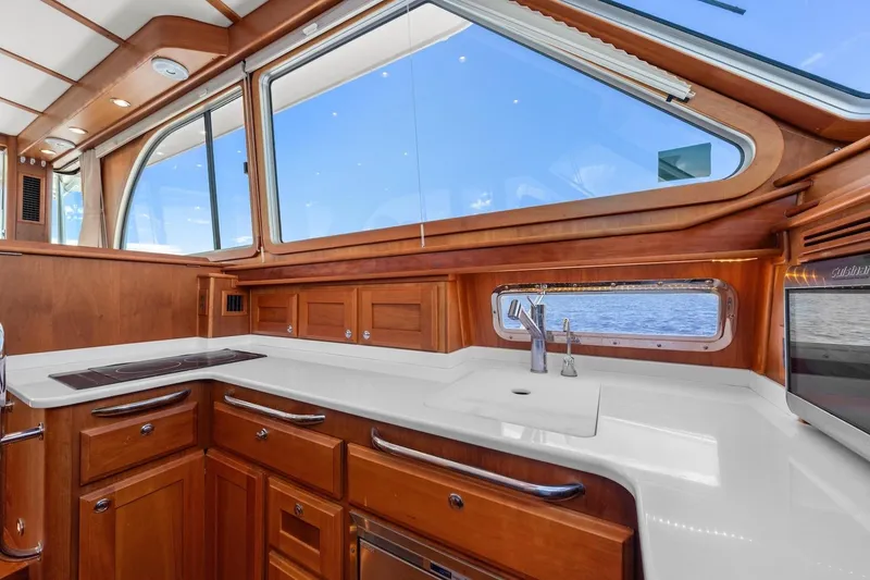 Slide: The Image of Luxurious interior of 2019 Sabre 45 Salon Express yacht with elegant wood cabinetry and large windows. - 17