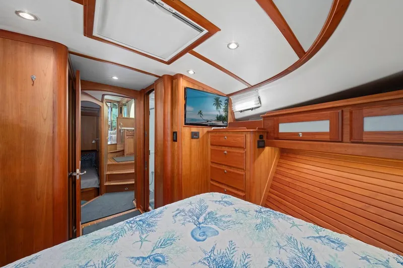 Slide: The Image of Luxurious 2019 Sabre 45 Salon Express yacht interior with wood finish and cozy bedroom. - 26