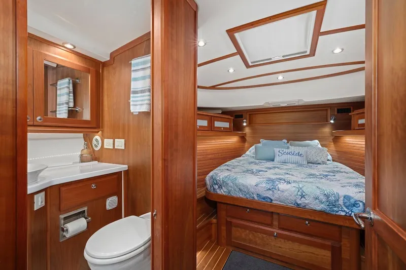 Slide: The Image of 2019 Sabre 45 Salon Express cabin with twin beds, wooden interior, and modern lighting. - 34