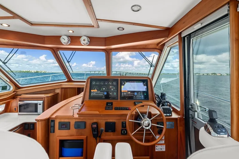 Slide: The Image of 2019 Sabre 45 Salon Express helm with digital displays and ocean view. - 50