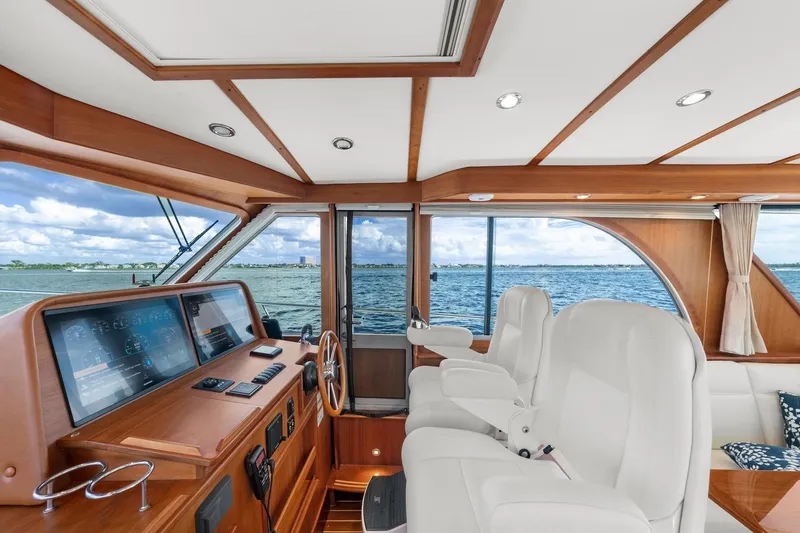 Slide: The Image of 2019 Sabre 45 Salon Express yacht with American flag, ocean view, and inflatable boat. - 55