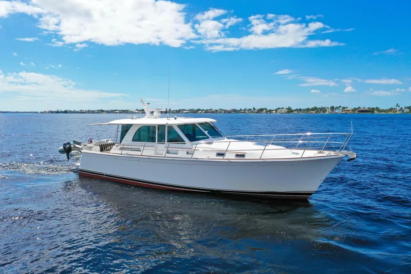 Slide: The Image of 2019 Sabre 45 Salon Express yacht cruising on open water under a clear blue sky. - 72