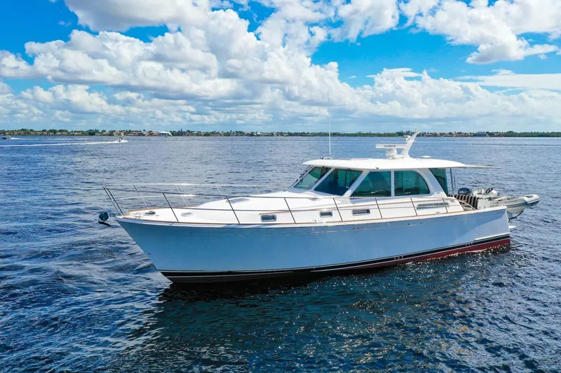Slide: The Image of 2019 Sabre 45 Salon Express yacht cruising on open water under a cloudy sky. - 76