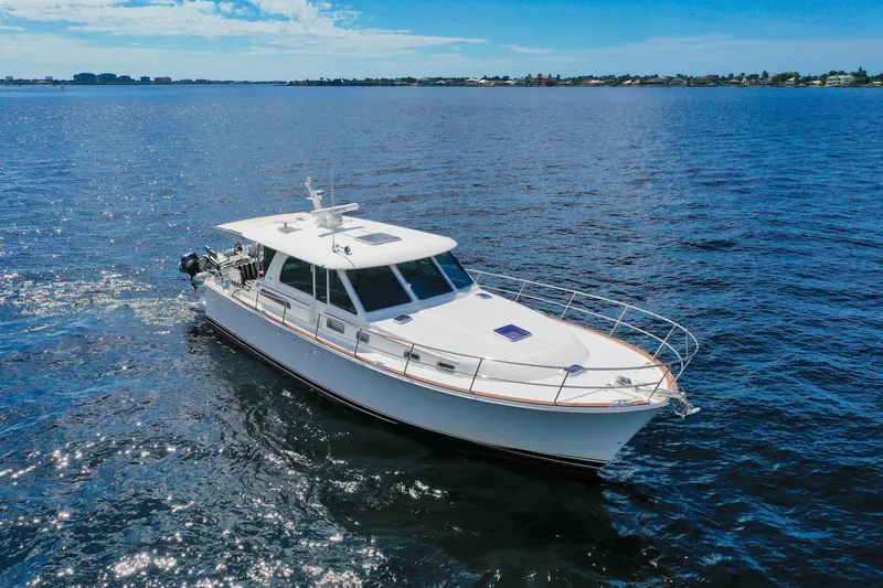 Slide: The Image of 2019 Sabre 45 Salon Express cruising on open water under a clear blue sky. - 82