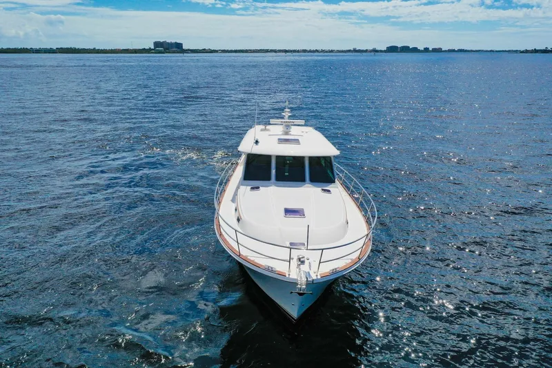 Slide: The Image of 2019 Sabre 45 Salon Express yacht cruising on open water under a partly cloudy sky. - 84