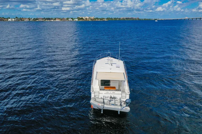 Slide: The Image of 2019 Sabre 45 Salon Express cruising on open water under a clear blue sky. - 87