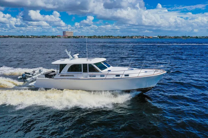 Slide: The Image of 2019 Sabre 45 Salon Express cruising on open water under a blue sky. - 91
