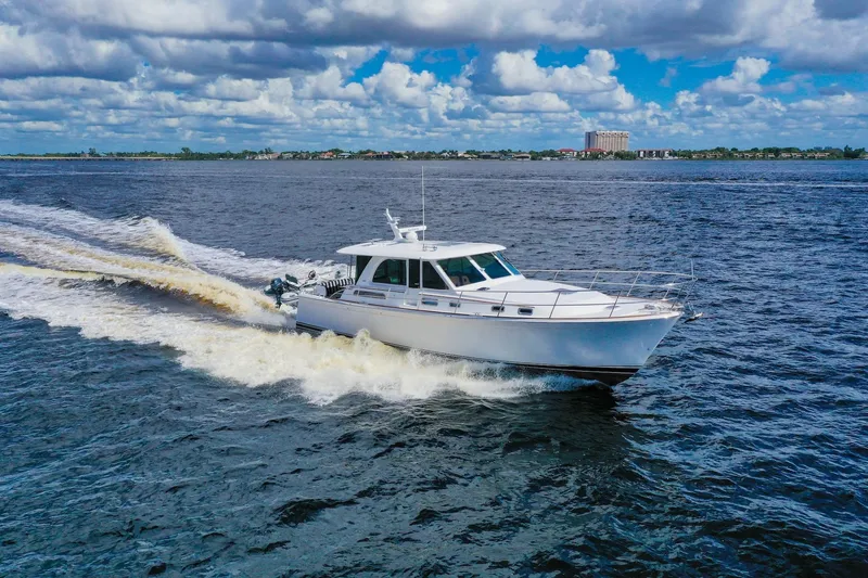 Slide: The Image of 2019 Sabre 45 Salon Express cruising on open water under a cloudy sky. - 92