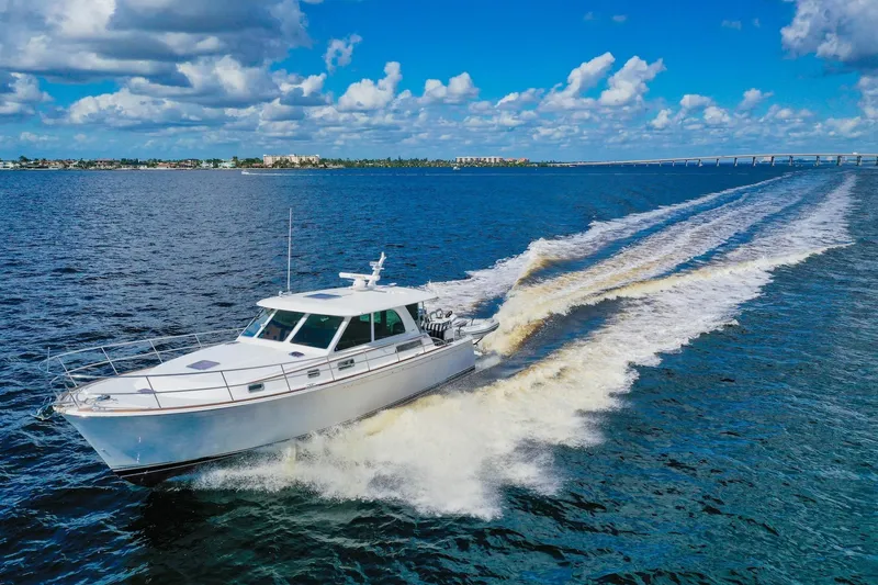 Slide: The Image of 2019 Sabre 45 Salon Express cruising on open water under a clear blue sky. - 97