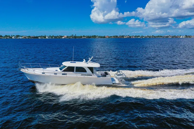 Slide: The Image of 2019 Sabre 45 Salon Express cruising on open water under a clear blue sky. - 99