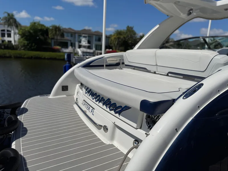 Slide: The Image of 2023 Formula 350 Crossover Bowrider docked by waterfront homes under blue sky. - 11