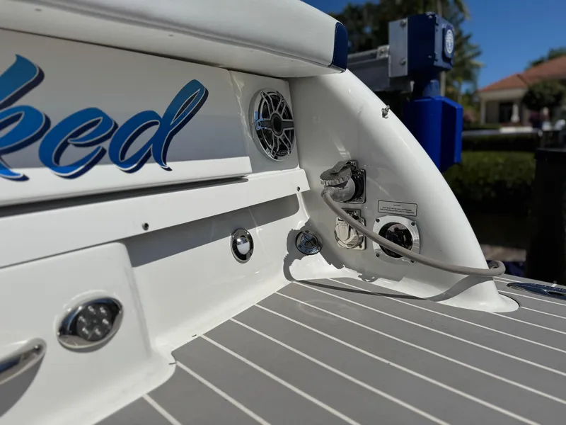 Slide: The Image of 2023 Formula 350 Crossover Bowrider boat deck with cable connections and sleek design. - 13
