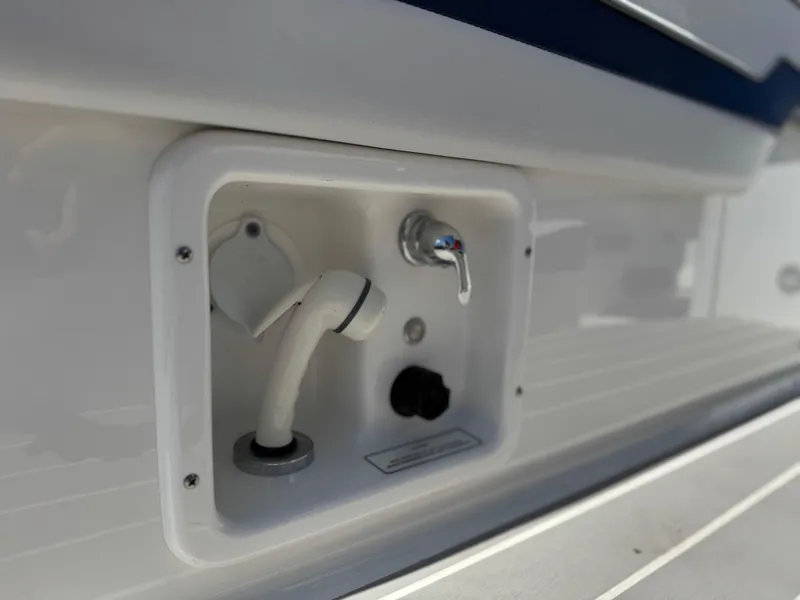 Slide: The Image of 2023 Formula 350 Crossover Bowrider water outlet and controls on deck. - 16