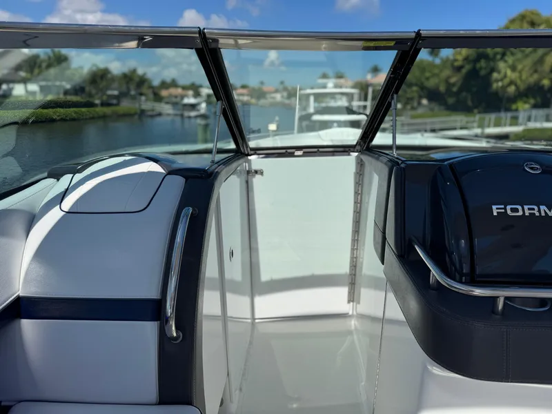 Slide: The Image of 2023 Formula 350 Crossover Bowrider interior with sleek design and waterfront view. - 34