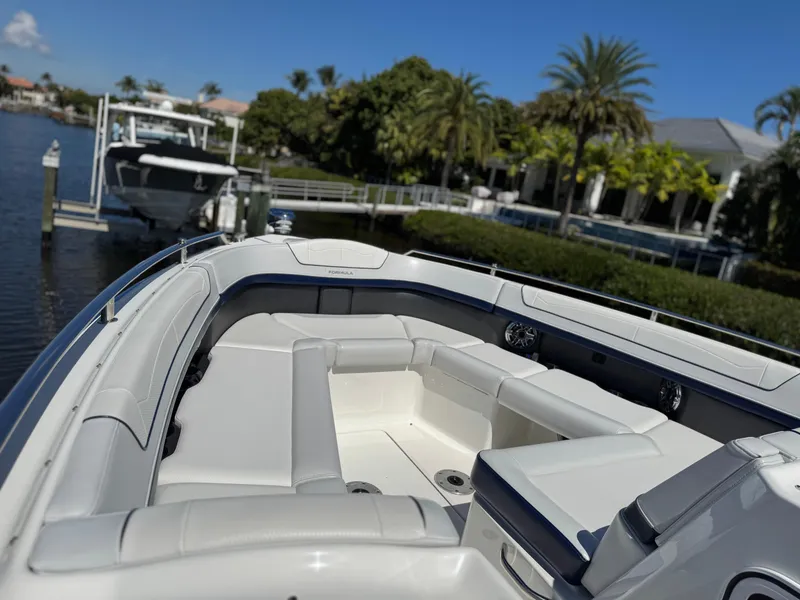 Slide: The Image of 2023 Formula 350 Crossover Bowrider docked, featuring spacious seating and sleek design. - 35
