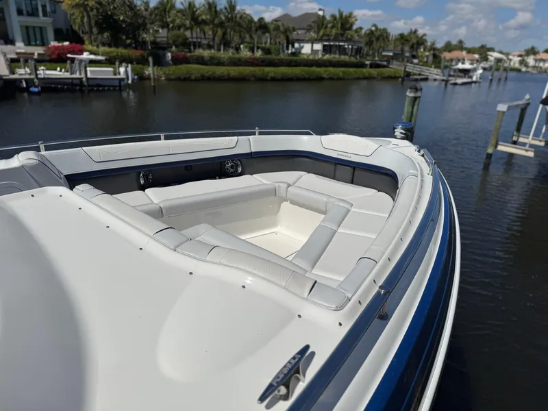 Slide: The Image of 2023 Formula 350 Crossover Bowrider on a scenic waterfront, showcasing luxurious seating. - 36