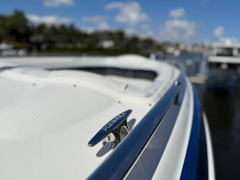 Slide: The Image of 2023 Formula 350 Crossover Bowrider, sleek design, docked on a sunny day. - 38