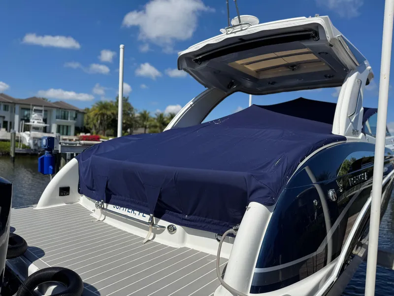 Slide: The Image of 2023 Formula 350 Crossover Bowrider docked, covered, with blue sky background. - 4