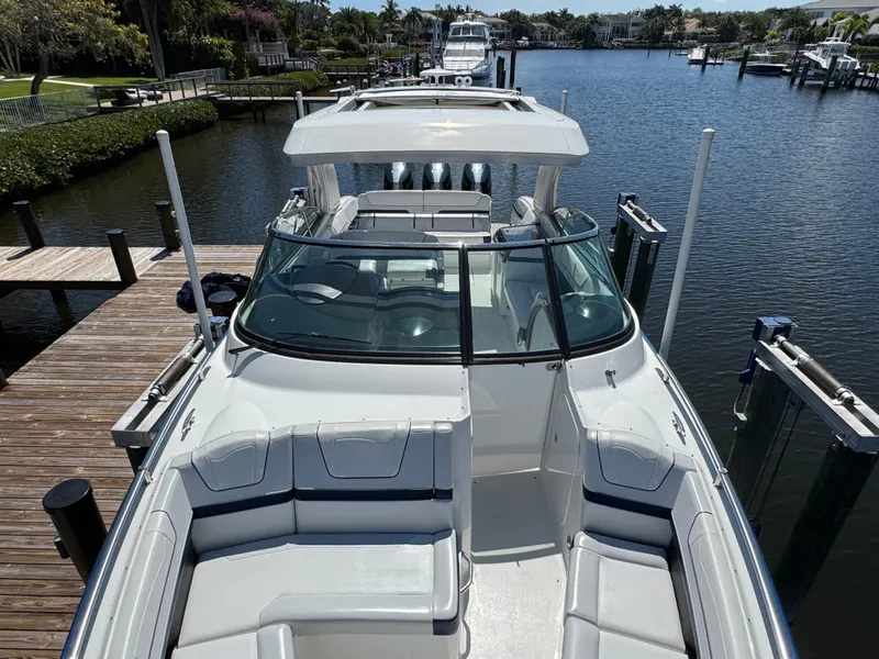 Slide: The Image of 2023 Formula 350 Crossover Bowrider docked in a scenic marina setting. - 40