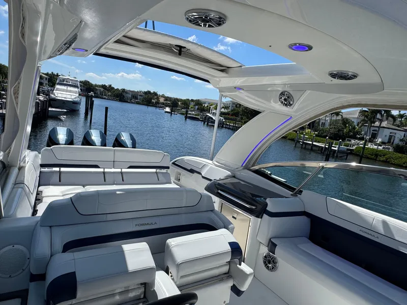 Slide: The Image of 2023 Formula 350 Crossover Bowrider interior with luxurious seating and scenic waterfront view. - 41