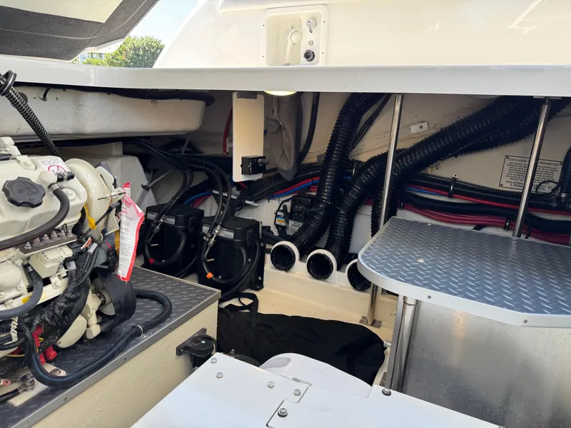 Slide: The Image of Engine compartment of 2023 Formula 350 Crossover Bowrider with visible wiring and components. - 46