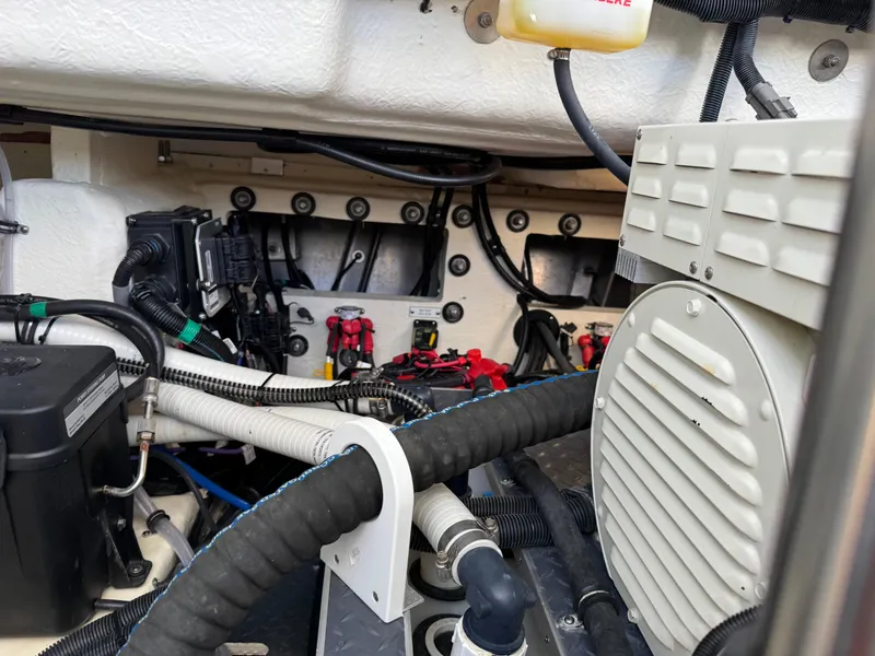 Slide: The Image of Engine compartment of 2023 Formula 350 Crossover Bowrider, showcasing wiring and mechanical components. - 49