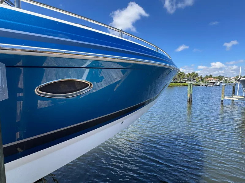 Slide: The Image of 2023 Formula 350 Crossover Bowrider on water, showcasing sleek blue hull design. - 6