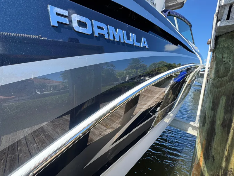 Slide: The Image of 2023 Formula 350 Crossover Bowrider docked, showcasing sleek design and branding. - 7