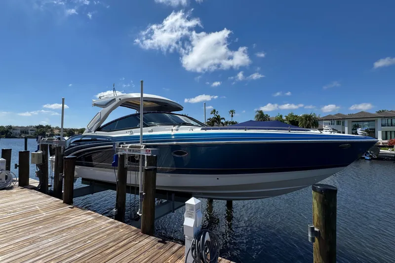 Slide: The Image of 2023 Formula 350 Crossover Bowrider docked, showcasing sleek design under a clear blue sky. - 8