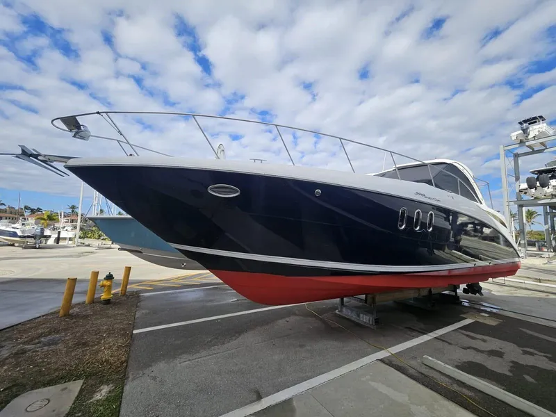 The Image of 2008 Cruisers Yachts 390 Sports Coupe on dry dock under a partly cloudy sky. - 0
