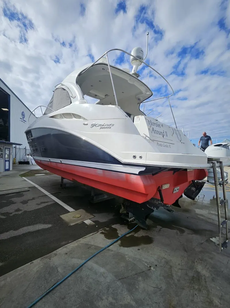 Slide: The Image of 2008 Cruisers Yachts 390 Sports Coupe on dry dock, showcasing sleek design and vibrant hull. - 1