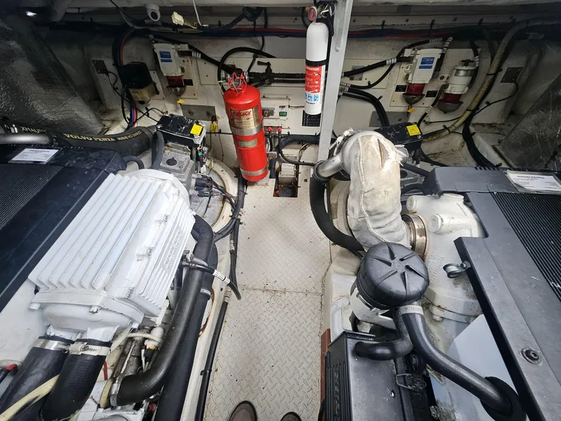 Slide: The Image of Engine room of 2008 Cruisers Yachts 390 Sports Coupe with fire extinguisher and mechanical components. - 10